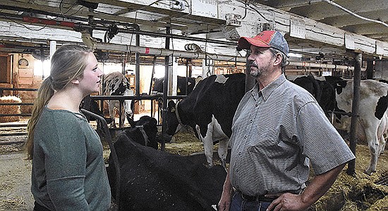 Christine and Tim Leonard talk about the day’s responsibilities in their tiestall barn on the family’s farm near Waconia, Minnesota. Christine joined the farm full time in January 2018. PHOTO BY MARK KLAPHAKE
