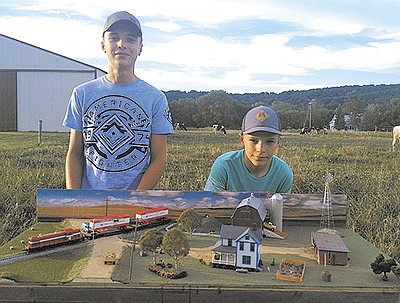 Bo (left) and Ian Afdahl show off their model railroading display at their family’s farm near Arkansaw, Wisconsin. The display captured top honors in the youth team division of the Walther’s Trains National Model Railroad Build-Off earlier this summer. PHOTO SUBMITTED
