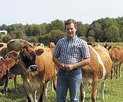 John Bigham, Jr., milks 30 cows at Charles and Barbara Wellner’s organic dairy farm near Abbotsford, Wisconsin. Bigham, of New Paris, Ohio, relocated to embark on a career as an organic dairy farmer. PHOTO BY DANIELLE NAUMAN