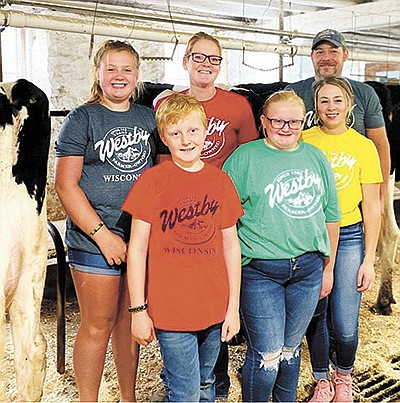 The Wells-Leis family – (front, from left) Gage, Haydn and Madaline Leis; (back, from left) Addison Leis, Beth Wells-Leis and Gabe Leis – milk 45 cows near Viroqua, Wisconsin. The family has been overwhelmed by the support they have received from their peers in the dairy industry in the face of a farm accident that left Gabe in the University of Wisconsin Hospital’s burn unit.  PHOTO SUBMITTED