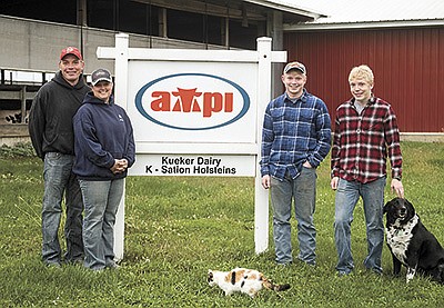 The Kuekers – (from left) Kevin, Cherish, Kyle and Caden – milk 80 cows near Waverly, Iowa. Kevin and Cherish are also coaches for the Waverly-Shell Rock High School cross-country team. PHOTO BY AARON THOMAS FOR DAIRY STAR