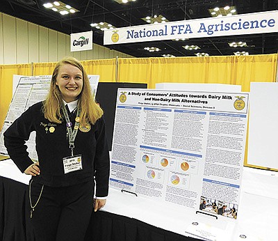 Paige Stuber stands next to her third research project at the 2019 National FFA Agriscience Fair competition. Stuber’s earned the Agriscience Research Integrated Systems Proficiency Award at this year’s virtual 93rd National FFA Convention and Expo Oct. 27-29.  PHOTO SUBMITTED