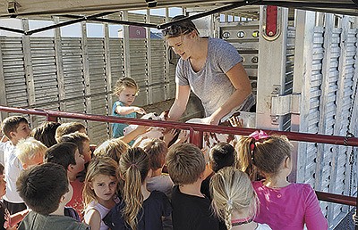 Agnes (left) and Karen Griffin show the 2019-2020 Kindergarten Project Calf, Golden, to the class in the school’s parking lot in September 2019 in Thief River Falls, Minnesota. PHOTO SUBMITTED