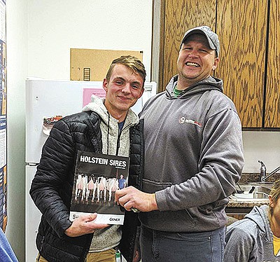 Kyle Rivet (left) and Phil Finger hold up a special door prize won by Rivet at the Fingers’ 2019 employee Christmas party. The Fingers milk 500 cows and farm 2,000 acres near Peshtigo, Wisconsin. PHOTO SUBMITTED