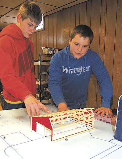 Cousins Dawson Ricklefs (left) and Keegan McElmeel plan an entry for the National Farm Toy Show on the Ricklefs’ dairy farm near Monticello, Iowa.  PHOTO BY SHERRY NEWELL