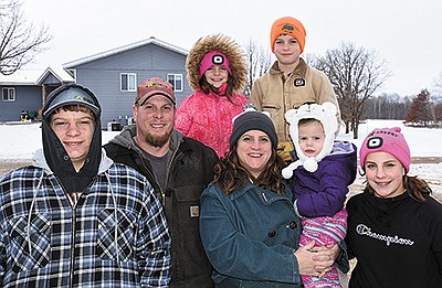 The Smude family – (front, from left) Brock, David, Joni holding Audrey and Josi; (back, from left) Ellie and Brady – milks 73 cows on their farm near Lastrup, Minnesota. PHOTOS BY MARK KLAPHAKE