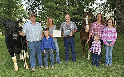 The Webster family – (from left) Aaron Twedt, Braydon Twedt, Jackie and Alan Webster, Bryleigh Twedt, Nikki Twedt, and Brooklyn Twedt – custom raises dairy heifers on their farm near Ortonville, Minnesota. They were named the 2020 Big Stone County Farm Family of the Year. PHOTO SUBMITTED