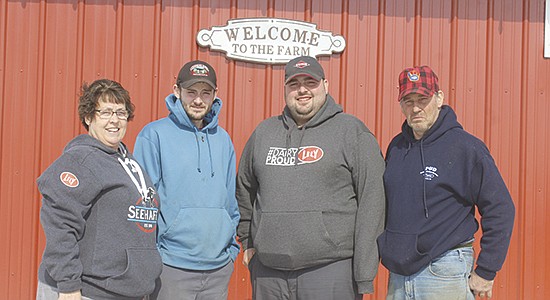 The Breyer family – (from left) Cindy, Derek, Dillon and Doug – milks 120 cows in their new robotic facility in Birnamwood, Wisconsin. PHOTO BY DANIELLE NAUMAN