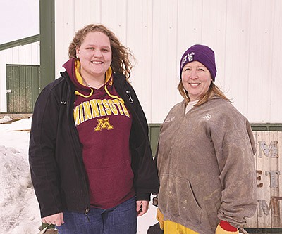 Cassandra Hinsch (left) works for Kristin Schrimpf and her family at Schrimpf Farms, where they milk 500 cows near Goodhue, Minnesota. The 17-year-old senior at Goodhue High School also works for her parents, Mike and Ann Hinsch, who raise heifers also near Goodhue, Minnesota.  PHOTO BY KRISTA KUZMA