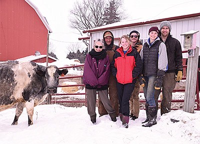 The Miller family – (from left) Julie, Stacy, Mika, Markus and Melendy – along with Melendy’s boyfriend, Greg Uecker, stand next to their 16-year-old cow, Frosty Face, on their 80-cow dairy near Plainview, Minnesota. PHOTO BY KRISTA KUZMA