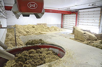 Feed ingredients are mixed in the mixing and feeding robot of the Rolfs’ Lely Vector feeding system March 4 at their farm near McIntosh, Minnesota. The family uses a kitchen to store three days’ worth of forages.  PHOTO BY JENNIFER COYNE