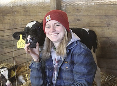 Abby Daul works during the week at Moravits Dairy in Bloomington, Wisconsin, then travels over three hours home on weekends to help her father on their family dairy near Mosinee, Wisconsin. She took time off from schooling during the pandemic. PHOTO BY DANIELLE NAUMAN