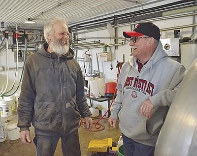 Richard Reiman (left) and Jim Skogquist visit in the milkhouse March 4 at the Reiman family’s dairy near Princeton, Minnesota. Reiman milks 40 cows now owned by his daughter, Kristen, and her husband, Thomas Duden. PHOTO BY ANDREA BORGERDING