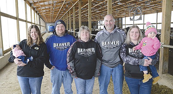 The Baudhuin family – (from left) Amy  holding Chloe, 2 months, Dustin, Lisa, Galen, and Brooke holding Brynlee, 19 months – milks 240 cows and farms about 600 acres near Brussels, Wisconsin.  PHOTO BY STACEY SMART