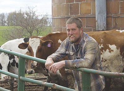 Adam Lang is the fourth generation to dairy farm in Winslow, Illinois. Lang milks 35 cows on the dairy, which was absent of cows for nearly 40 years.  PHOTO BY DANIELLE NAUMAN