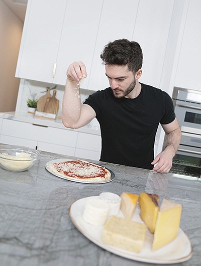 Jordan Maron, a gaming influencer known online as CaptainSparklez, puts cheese on a pizza during a promotion with Dairy Management Inc.  PHOTO SUBMITTED