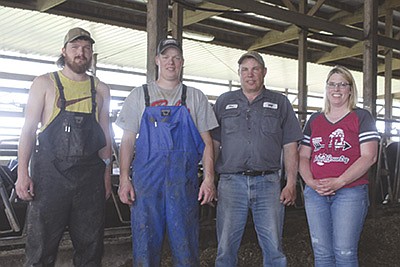 Luckwaldt Agriculture’s management team – (from left) herdsmen Derek Fenner and Patrick Kuselik; and owners Dan and Mary Luckwaldt – oversees the 1,275-cow dairy near Woodville, Wisconsin.  PHOTO BY DANIELLE NAUMAN