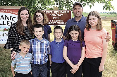 The Donnays – (front, from left) Adam, Ryan, Timmy, Elizabeth and Emma; (back, from left) Erin, Ellie and Kevin – milk 60 cows on their organic dairy farm in Stearns County near Kimball, Minnesota. The Donnays’ family farm was recognized as a century farm in 2020. 