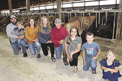 Aaron and Jessica Radermacher with their children – (from left) Asher (held by Aaron), Faith, Aiden, Lilly, Austin and Maria – milk 200 cows on their farm near Brooten, Minnesota. 