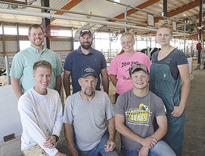 The team – (front, from left) Tanner Schmaling, John Schmaling and herdsman, Korey Oechsle; (back, from left) Dan Vivian of SVS Repro, Dan Gander of SVS Repro, herdsman Taylor Haeft and Dr. Dagmara Schroeder of Stateline Veterinary Service, (front row, from left) – operates Maple-Leigh Futures near Delavan, Wisconsin. Tanner Schmaling founded the dairy business in 2017. PHOTO BY STACEY SMART
