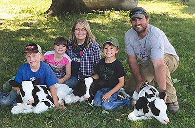 The Dahl family – (from left) Cashton, Jaxie, Steph, Bricker and Josh – pose with the triplet calves born June 16 on their 200-cow dairy near Rushford, Minnesota.