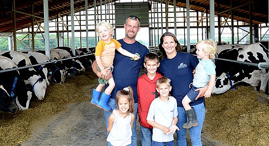  The Vanderstappen family – (front, from left) Addison and Jack; (back, from left) David holding Owen, Clark, and Katie holding Lane –  milks 130 cows and farm 300 acres near Hebron, Illinois. PHOTO BY STACEY SMART