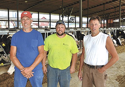 The Ainsworth family – (from left) Jim, Matt and Kevin – run Shawland Dairy where they milk 120 cows with two Lely A5 robots and farm 400 acres near Shawano, Wisconsin. The Ainsworths switched from parlor milking to robots in 2019. PHOTO BY STACEY SMART