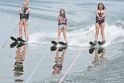 The Dombeck sisters – (from left) Morgan, Karlie and Taylor – water ski Aug. 2 on Big Pine Lake in Otter Tail County near Perham, Minnesota. The girls learned how to ski a few years ago.  PHOTO BY MARK KLAPHAKE