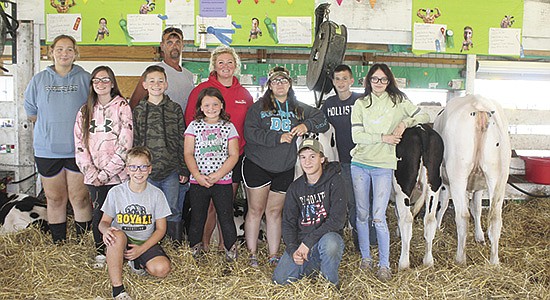 Valley Hill Farms exhibitors – (front, from left) Garrett and Turner Calhoun; (middle, from left) Kaleah Pfaff, Evie and Caed Hubbard, Electra Wilson, Madisol Elizondo, Ethan Hubbard and Marissa Kruckeberg; (back, from left) Brian Friske and Jeannie Jones – attend the Juneau County Fair Aug. 18-22 in Mauston, Wisconsin. Friske and Jones take the time to help non-farm youth experience the dairy industry through a dairy project.  PHOTO BY DANIELLE NAUMAN