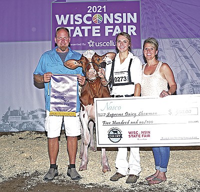Kylie Nickels wins supreme dairy showman with Lyn-Vale Warrior Rose-Red Aug. 5 at the Wisconsin State Fair. She is pictured with her parents, Tom and Penni Nickels, of Watertown, Wisconsin. PHOTO SUBMITTED