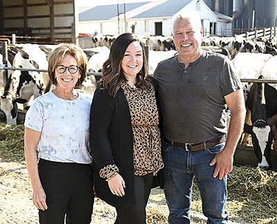 Kate Keenan (center) works alongside her parents, Bonnie and John Mohr, at their farm near Glencoe, Minnesota. Keenan is the office manager at her mother’s art studio and works with her dad on various tasks for the 100-cow dairy. PHOTO BY JENNIFER COYNE