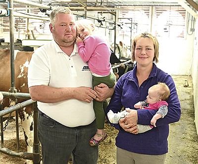 The Gerads family – Jason, holding Samantha, and Lynn, holding Camille – milk 72 cows on their dairy in Stearns County near Albany, Minnesota.  PHOTO BY JENNIFER COYNE
