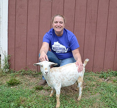 Amy Hackbarth poses with Dacquiri, one of her Nigerian Dwarf goats. Hackbarth milks five goats near Sussex, Wisconsin.  PHOTO BY STACEY SMART