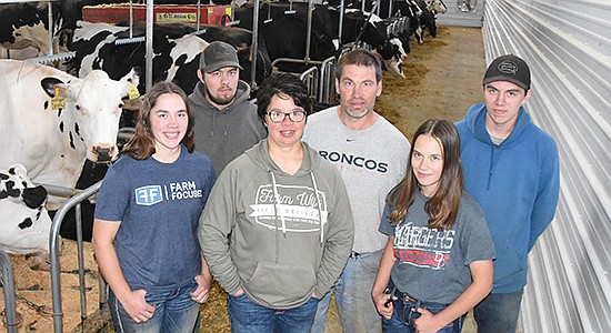 The Hendricksons – (front, from left) Sarah, Lynn and Jill; (back, from left) Ryan, Peter-Mark and Bradley – recently added 50 stalls on to their tiestall barn near Menahga, Minnesota. The addition was built to accomodate Ryan and Sarah’s interest in farming.  PHOTO BY MARK KLAPHAKE