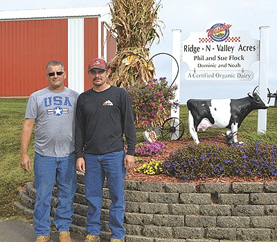 Phil Flock (left) is teaching his son, Noah, the ins and outs of organic dairying so that Noah can continue when Phil is ready to retire.  PHOTO BY ABBY WIEDMEYER