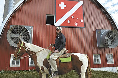Dan Wegmueller sits atop one of his favorite horses, Chazz, at Wegmueller  Farm near Monroe, Wisconsin. Wegmueller and his wife, Ashley, milk 40 cows and run an Airbnb on the property. PHOTO BY STACEY SMART