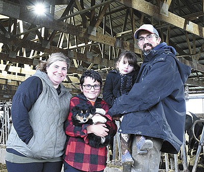 Tiffany and Tony Betcher and their children – (from left) Aaron and Alexis – milk 120 cows near Goodhue, Minnesota.  PHOTO BY KATE RECHTZIGEL