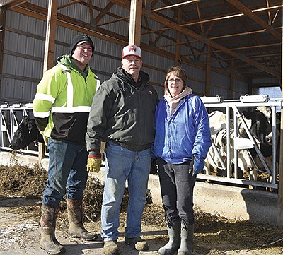 Peter, Jim and Marilyn Schumer stand in front of their new loose-housing facility on their farm near St. Stephen, Minnesota. PHOTO BY MARK KLAPHAKE