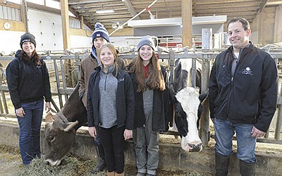 The Meyer family – (from left) Jennifer, Austin, Abby, Brianna and Larry – are pictured with their two 16-year-old cows, Treat (left) and Malorie. The Meyers milk 130 cows with two robots near Chilton, Wisconsin.  PHOTO BY STACEY SMART