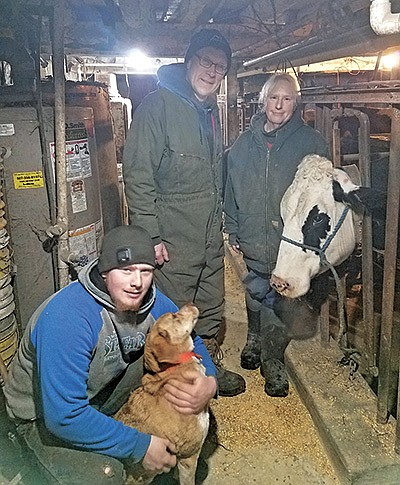 Buck Oeltjenbruns is pictured with his parents, Curt Oeltjenbruns and Mary Buck, on their farm near West Concord, Minnesota. Oeltjenbruns is a senior at Kenyon-Wanamingo High School. PHOTO BY KATE RECHTZIGEL