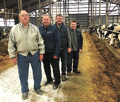The Rickerts – (from left) Don, Jim, Andrew and Miles – stand in their 1,200-cow freestall barn Jan. 6 on their farm in Fond du Lac County near Eldorado, Wisconsin. Don Rickert has been influential in progressing the farm through the decades. PHOTO BY KATI KINDSCHUH