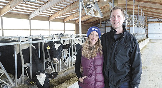 Rachel and Kyle Zwieg stand in their robotic barn built in 2020 at their farm near Ixonia, Wisconsin. The Zwiegs are this year’s winner of the Wisconsin Outstanding Young Farmer award.  PHOTO BY STACEY SMART