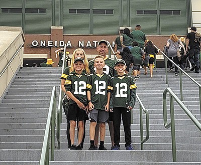 Dan and Melanie Brick and their children – (from left) Ian, Sawyer and Elijah – stand outside of Lambeau Field in Green Bay, Wisconsin. The Bricks milk 1,000 cows and farm 1,200 acres near Greenleaf, Wisconsin, and enjoy attending Green Bay Packers games and practices. PHOTO SUBMITTED