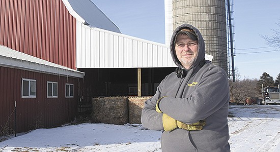 Brad Robinson stands in his farmyard Feb. 14 on his 54-cow dairy near Lester Prairie, Minnesota. Robinson trucked for many years before starting his dairy career in the fall of 2020. PHOTO BY MARK KLAPHAKE