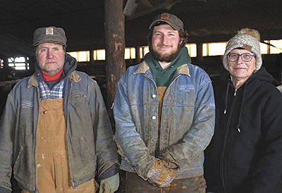 Jim, Nick and Cassie Halama stand in their barn Feb. 7 at their farm near Independence, Wisconsin. The Halamas milk 160 cows on their organic dairy. PHOTO BY ABBY WIEDMEYER