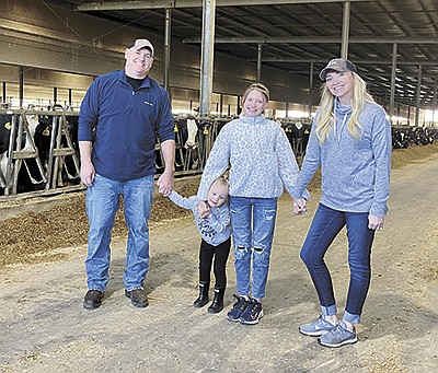 The Bartons – (from left) Evan, Maci, Mariah and Kayleigh – stand in their barn at South Fork Dairy near Newark, Ohio. The Bartons milk 2,600 cows and farm 2,500 acres at this location and also own two other farms in partnership – one in Ohio and one in Michigan.  PHOTO SUBMITTED
