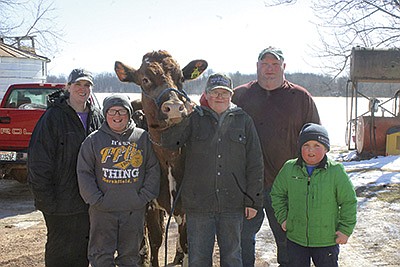 The Offer family – (from left) Shauna, Peyton, Hunter, John and Tanner – stand with a herd favorite, Ellie, on their farm near Auburndale, Wisconsin. John was named the Distinguished Breeder at the 2022 Wisconsin Ayrshire Meeting held March 5 in Tomah, Wisconsin.  PHOTO BY DANIELLE NAUMAN
