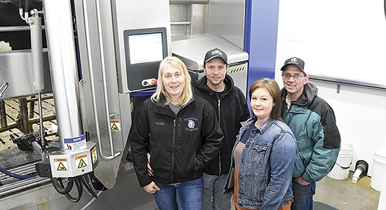 The Rotzes – Carolin and Paul and Stacey and Philip – milk 66 cows with a DeLaval VMS V300 robot on their dairy farm in Otter Tail County near Pelican Rapids, Minnesota. The robot became operational Sept. 7, 2021.  PHOTO BY JENNIFER COYNE