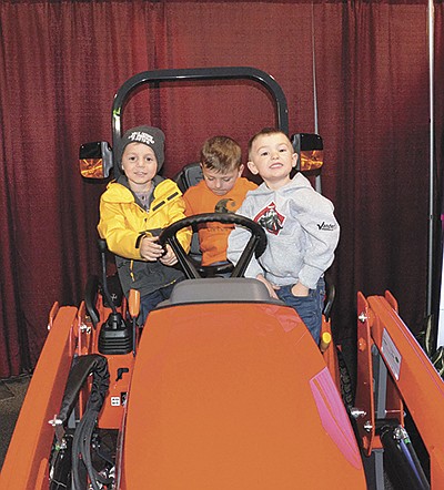 Creed Blasczyk (from left), Cole Cowling and Jack Vanderloop check out farm equipment at the WPS Farm Show March 31 in Oshkosh, Wisconsin. The boys are all from Neenah, Wisconsin. PHOTO BY STACEY SMART