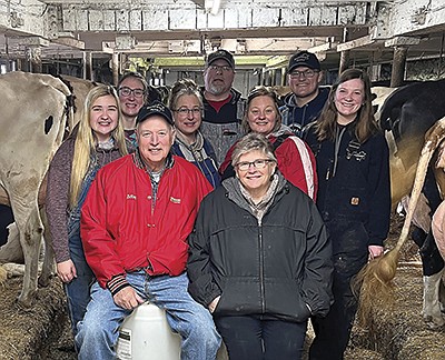 The Kurth family – (front, from left) LeRoy and Susan; (middle, from left) Shelby Swanson, Kari Swanson, Kacie and Rachel; (back, from left) Sierra Swanson, Michael and Chandler – are one of the 2022 Minnesota Purebred Dairy Cattle Association’s Distinguished Breeder. The Kurths milk 85 cows near Stewart, Minnesota. Not pictured are Christian Kurth, Brianna Kurth and Mackenzie Swanson. PHOTO BY GRACE JEURISSEN
